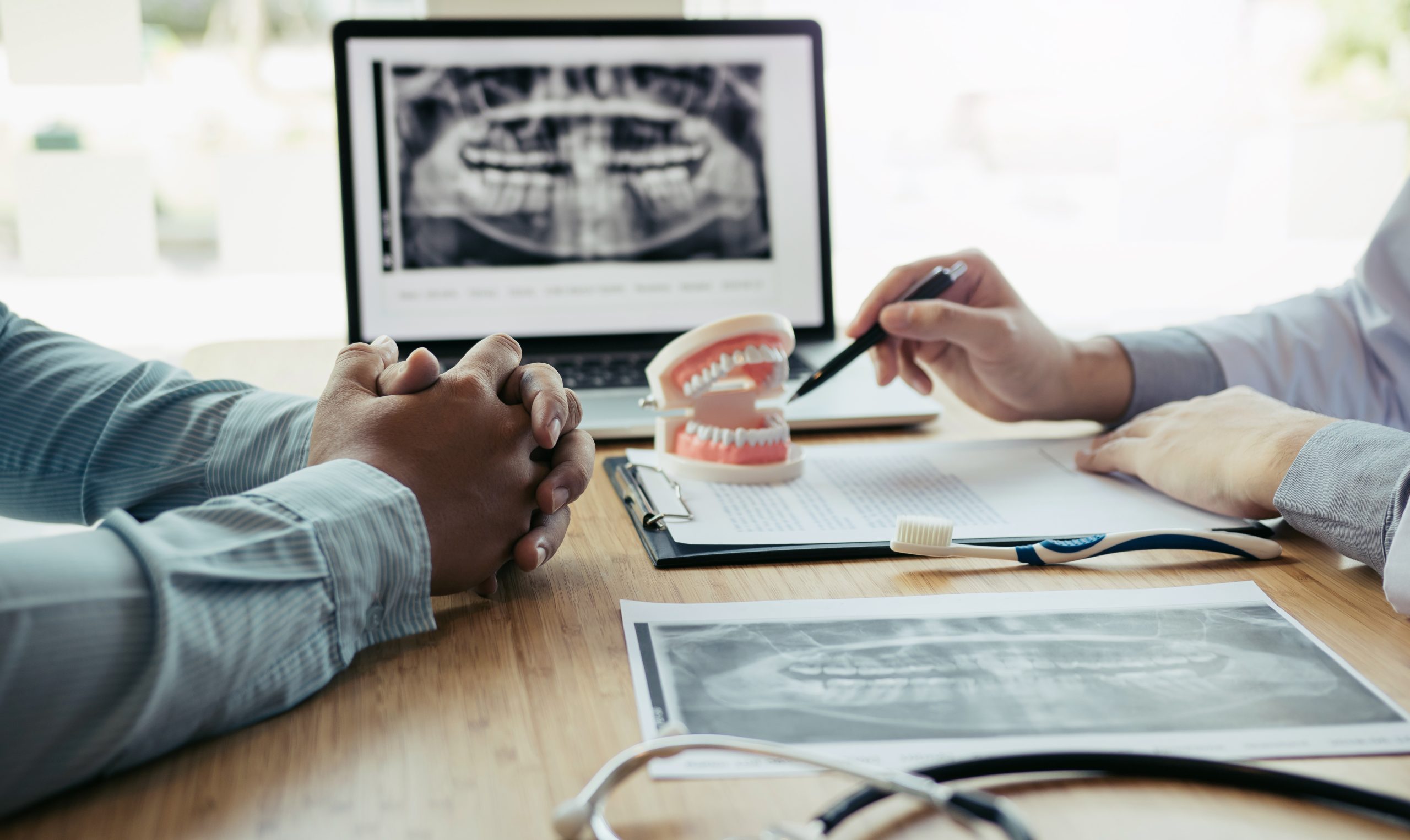 Dentists Are Discussing Dental Problems At Report X Ray Image On