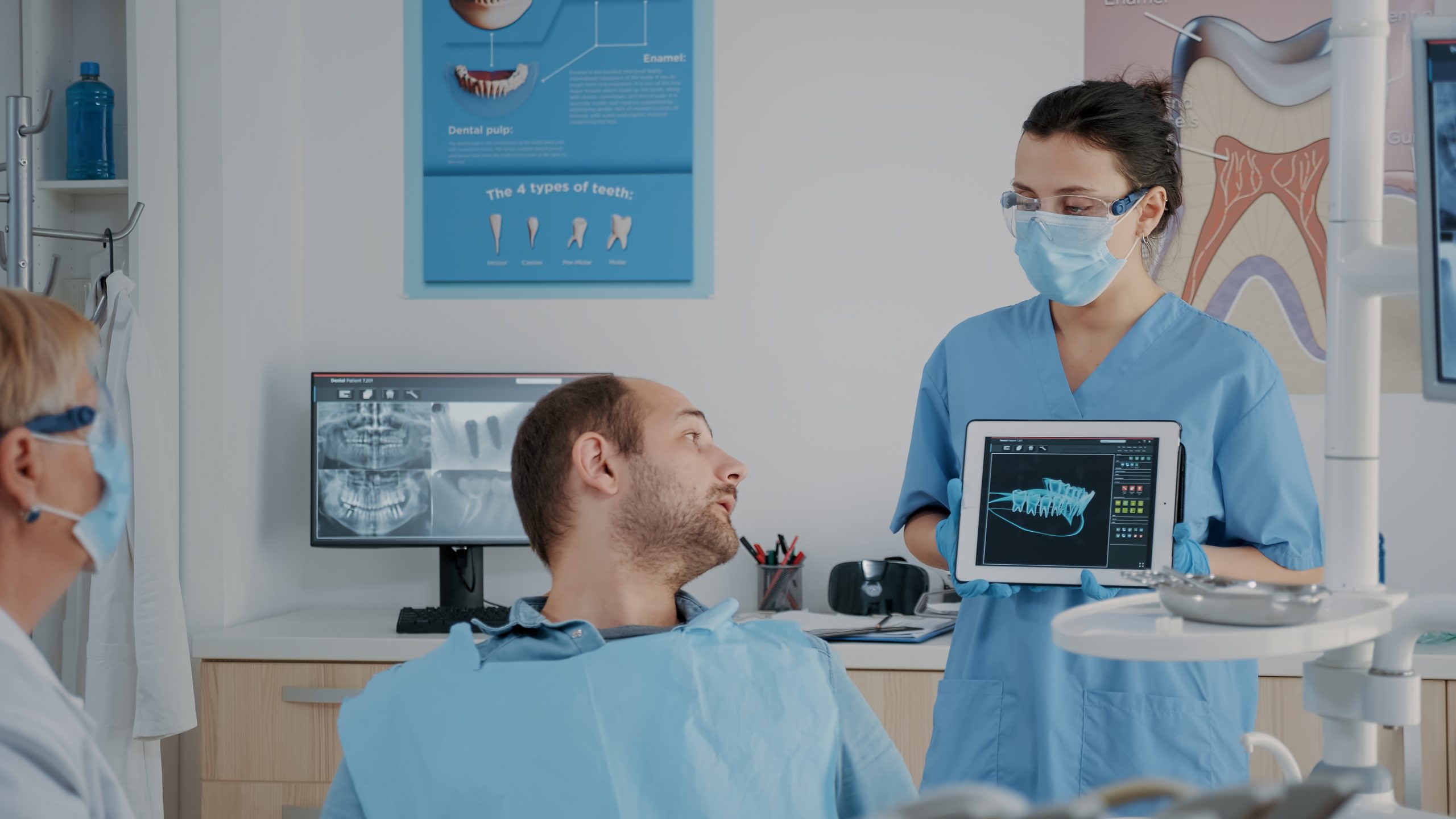 Stomatological Team Pointing At Denture Radiography On Tablet